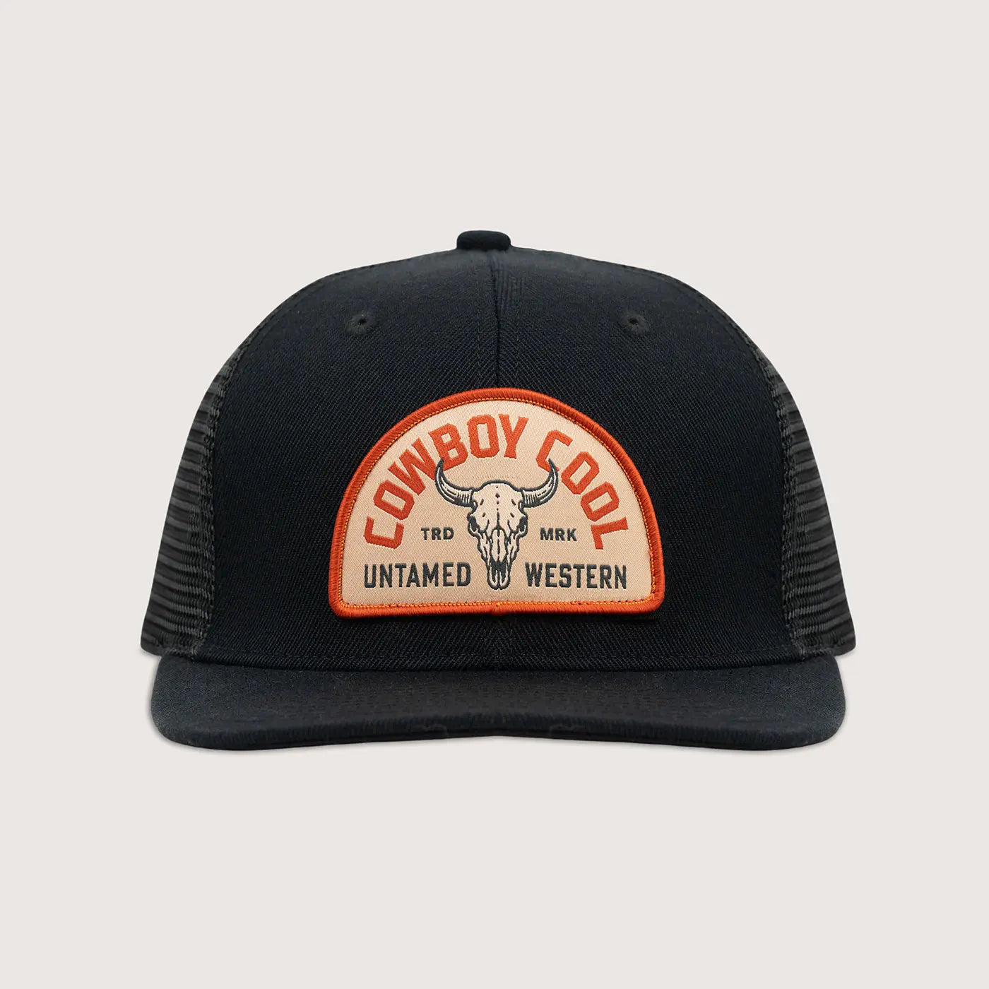 Front view of Cowboy Cool Badlands Hat in black with mesh back and bison skull patch featuring Untamed Western branding, snapback trucker design