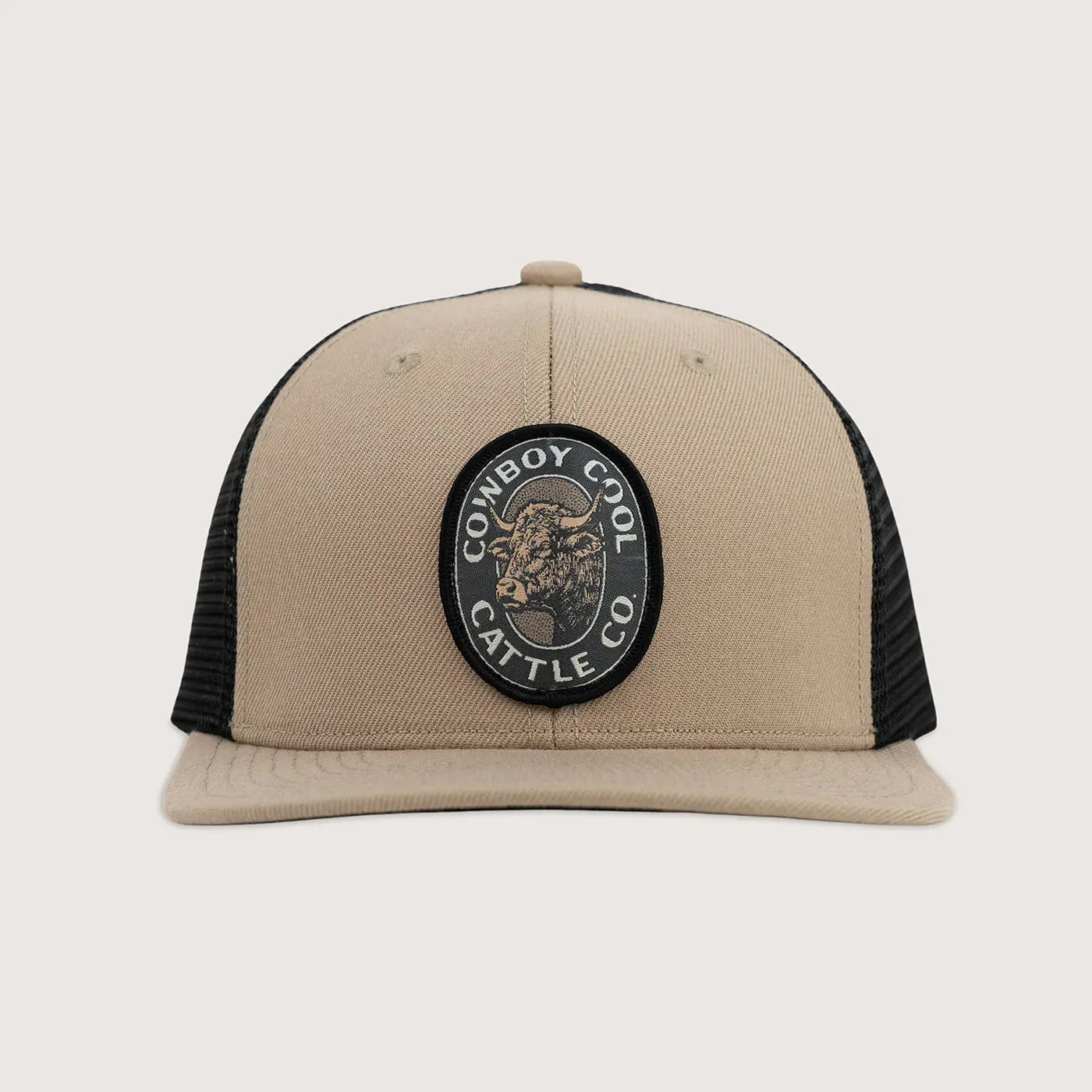 Beige and black cap with 'Cowboy Cool Cattle Co' patch on a light gray background