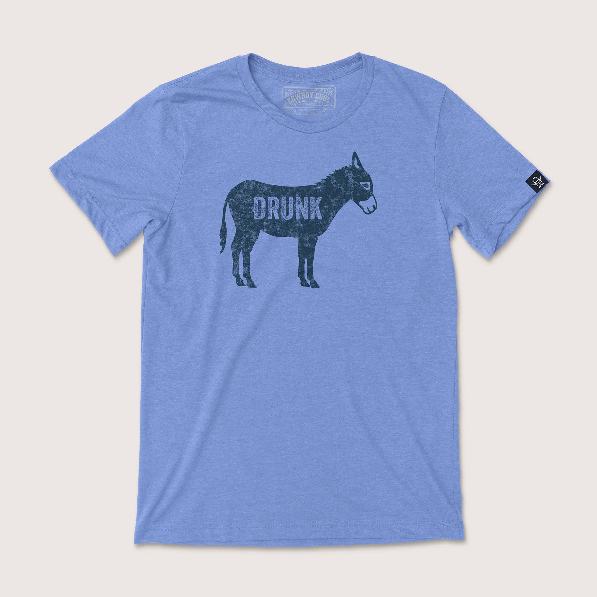 Cowboy Cool Drunk A$$ T-Shirt in heather Carolina blue, featuring a distressed navy donkey graphic with the word 'DRUNK' printed across the body.