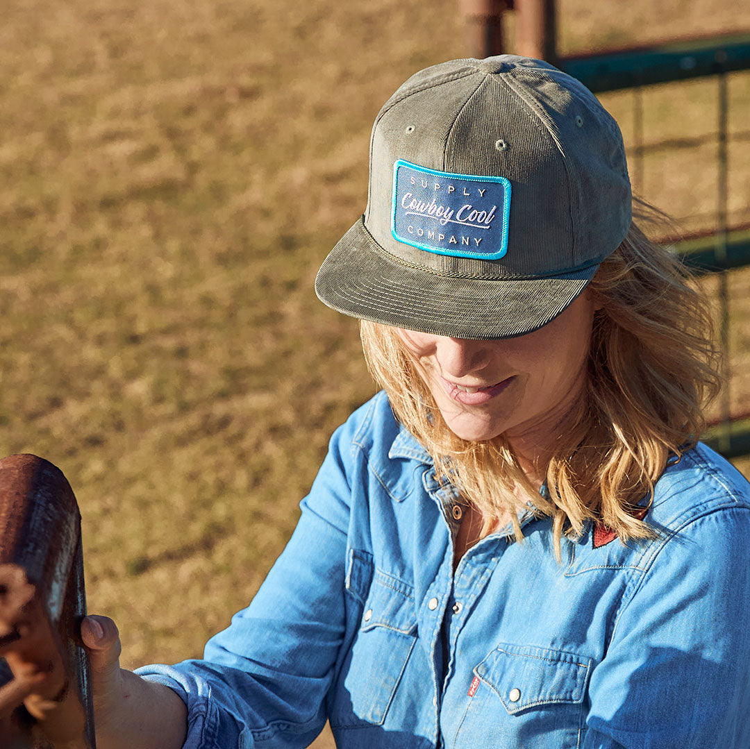 A top view of a woman wearing a corduroy Cowboy Cool Houlihan Hat in  olive.