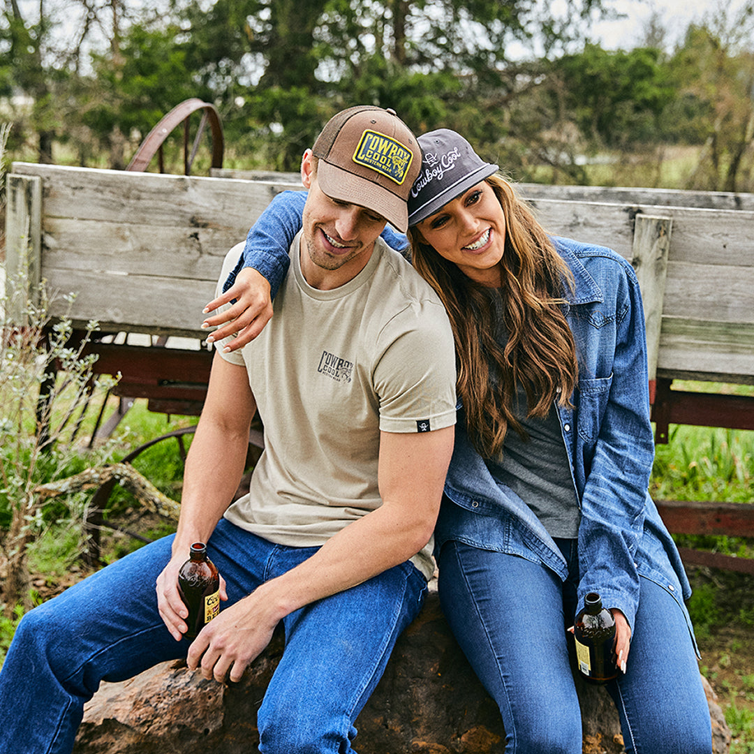 A couple in their 20's wearing cowboy cool apparel.