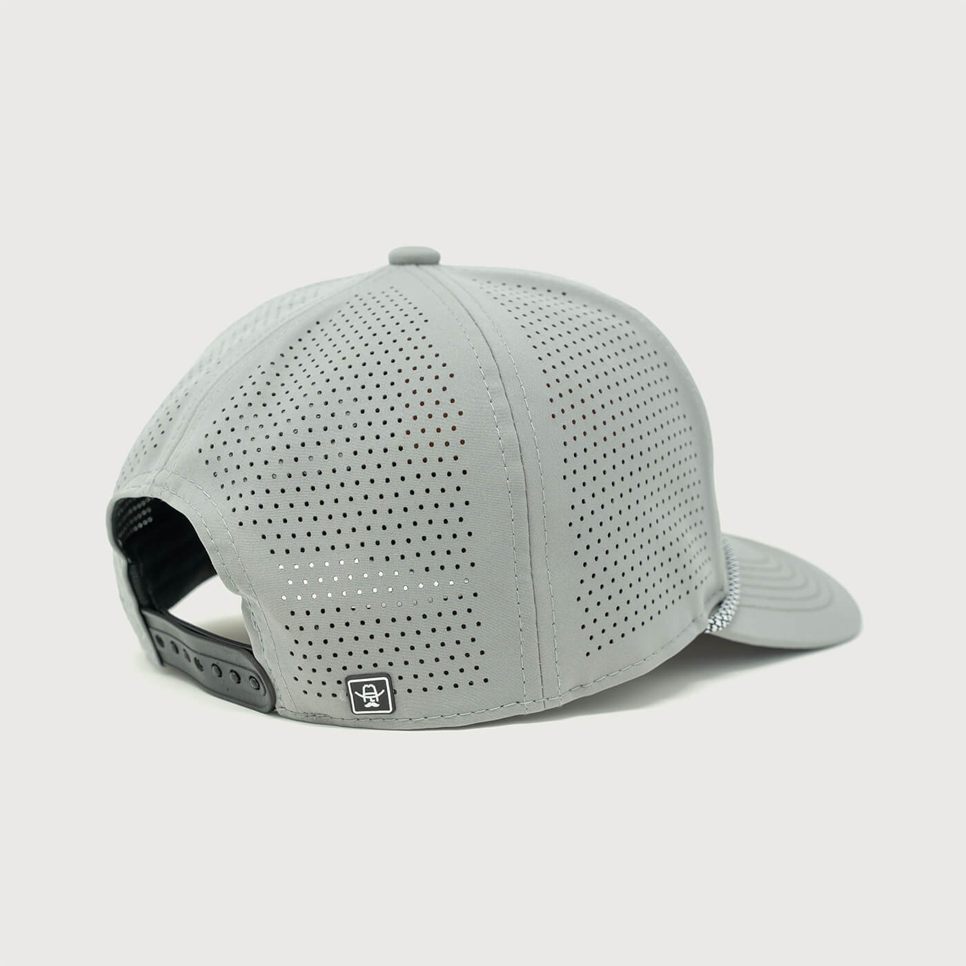 Back view of the Cowboy Cool Maverick Hat highlighting the perforated panels for breathability, adjustable snapback closure, and a small woven icon tag.