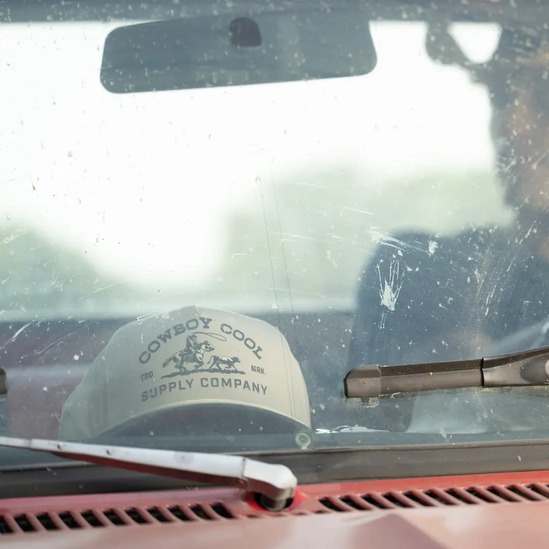 Cowboy Cool Roper Hat sitting on the dash of a team ropers pickup truck. 