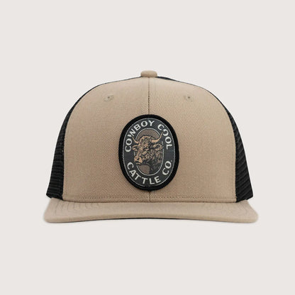 Beige and black cap with 'Cowboy Cool Cattle Co' patch on a light gray background