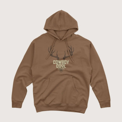 Brown western hoodie with 'Cowboy Cool Outdoors' graphic with a deer skull on a light beige background