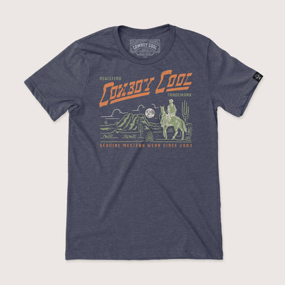 Cowboy Cool Lone Ranger T-Shirt in heather midnight navy, featuring a desert scene with cactus, mountains, and a cowboy riding under a full moon, with retro Western Wear design.