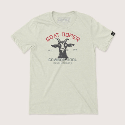 Goat Doper Western Wear T-Shirt by Cowboy Cool in heather oatmeal, featuring a rebellious goat with a cigar and bold 'Goat Doper' text above 'Untamed Western Wear' branding.
