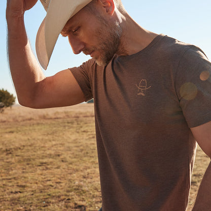 Front view of a model wearing a brown Cowboy Cool Vintage Beer T-Shirt