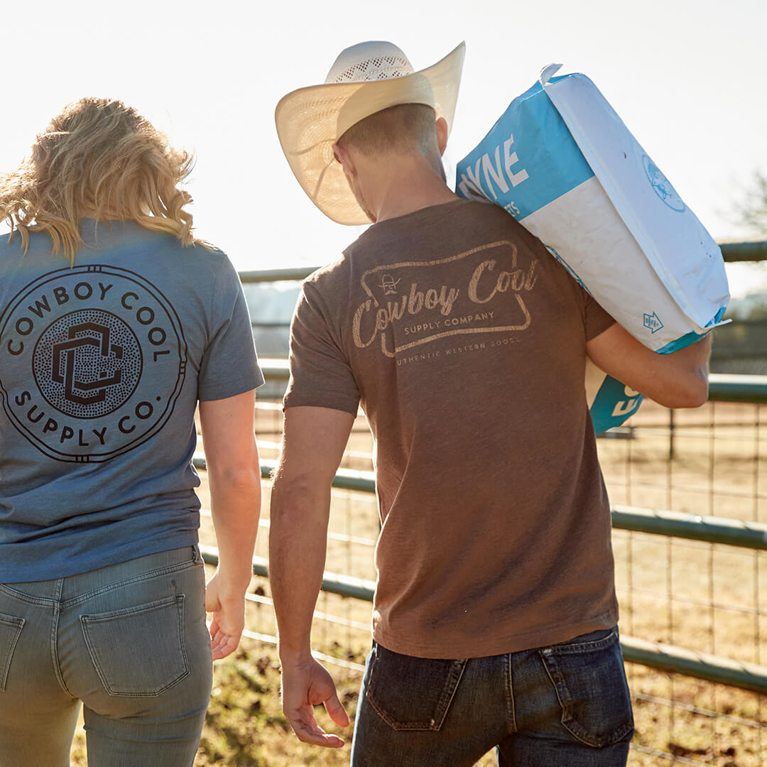 A couple walking with the male wearing a Front view of a model wearing a brown Cowboy Cool Vintage Beer T-Shirt